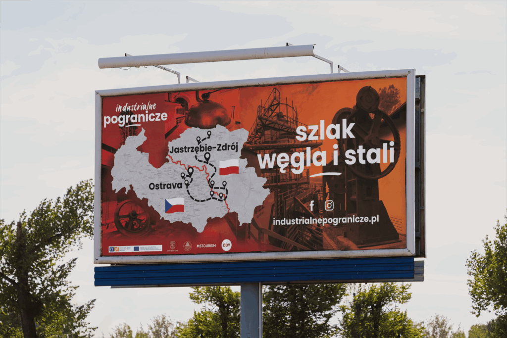 Polská verze billboardu propagující projekt spojující industriální památky v Moravskoslezském kraji a Slezském vojvodství.